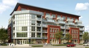 Toronto apartment for rent - A modern building with a red brick facade and large windows.