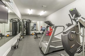 Toronto apartment for rent - A gym with treadmills, weights, and exercise equipment.