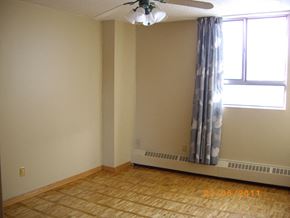 Toronto apartment for rent - A room with a window and a ceiling fan.