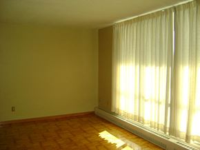 Toronto apartment for rent - A room with a window covered by white curtains.