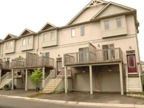 Waterloo apartment for rent - A two story house with a red door and a balcony.