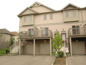 Waterloo apartment for rent - A two story beige house with a balcony on the second floor.