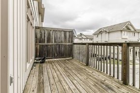 Waterloo apartment for rent - A wooden deck with a bench and a building in the background.