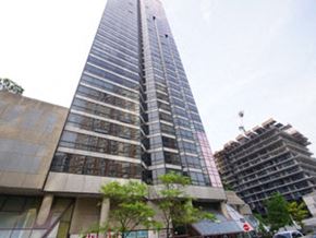 Toronto apartment for rent - A tall building with a lot of windows is in the background.