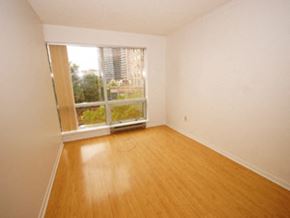 Toronto apartment for rent - Empty room with a window overlooking a city.