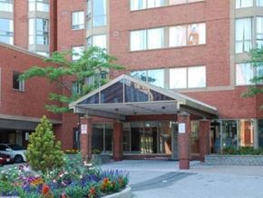 Toronto apartment for rent - A building with a red brick facade and a glass entrance.