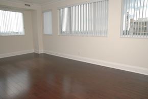 Toronto apartment for rent - A room with wooden floors and white walls.