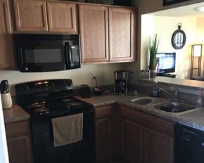 Jackson townhouse for rent - a kitchen with a stove microwave and a sink