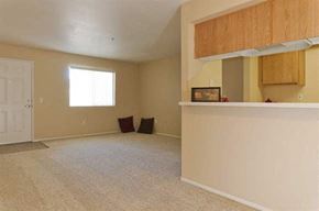 Cathedral City apartment for rent - an empty living room with a kitchen and a door
