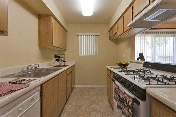 Cathedral City apartment for rent - a kitchen with a stove top oven and a sink