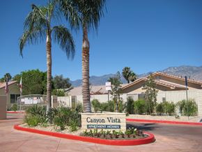 Cathedral City apartment for rent - a sign for campo vista with palm trees in front of a building