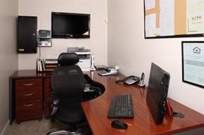 Mobile apartment for rent - a desk with a computer monitor and a chair