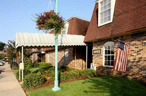 Mobile apartment for rent - an flag on a pole in front of a brick building
