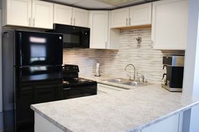 Florence townhouse for rent - a kitchen with black appliances and a white counter top at at Wentworth Estates Apartments, Florence, KY, 41042