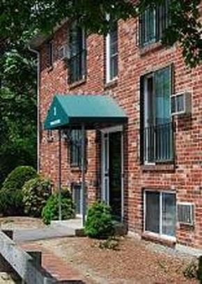 Milford apartment for rent - a brick building with a green awning on the front
