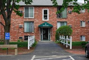 Milford apartment for rent - a red brick apartment building with a sidewalk in front of it