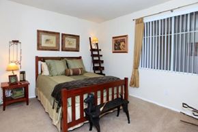 Merrimack apartment for rent - a bedroom with a bed and a large window