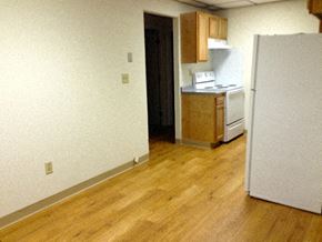 Manchester apartment for rent - an empty room with a refrigerator and a kitchen