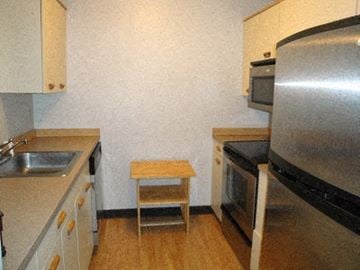 Manchester apartment for rent - a small kitchen with a sink and a refrigerator