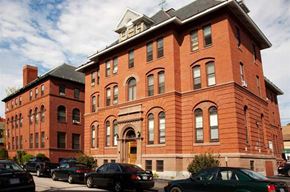 Manchester apartment for rent - a red brick building with cars parked in front of it