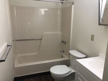 Laconia apartment for rent - a bathroom with a toilet and a tub and a sink