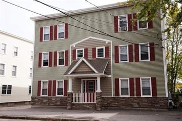 Manchester apartment for rent - a house with red shutters and a porch on a street