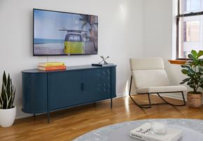 Hoboken apartment for rent - a living room with a cabinet and a tv on the wall