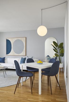 Hoboken apartment for rent - a dining room with a white table and blue chairs