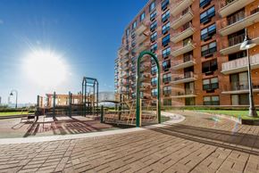 Hoboken apartment for rent - a playground in front of an apartment building with the sun shining