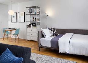 Hoboken apartment for rent - a bedroom with a bed and a desk and a chair