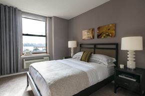 Hoboken apartment for rent - a bedroom with a large bed and a window