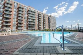 Hoboken apartment for rent - a swimming pool with a building in the background