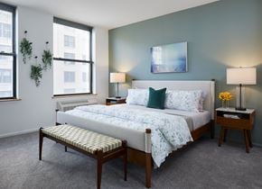 Hoboken apartment for rent - a bedroom with a bed and two windows