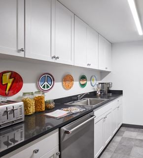 Hoboken apartment for rent - a kitchen with white cabinets and a sink