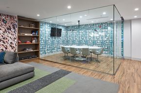 Hoboken apartment for rent - a conference room with a table and chairs and a wall of mirrors