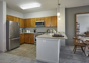 Harrison apartment for rent - a kitchen with stainless steel appliances and wooden cabinets