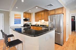Brookline apartment for rent - a kitchen with a granite counter top and a stainless steel refrigerator