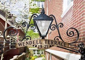 Cambridge apartment for rent - a street sign on the side of a brick building