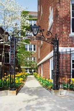 Cambridge apartment for rent - a sidewalk in front of a brick building with a wrought iron gate