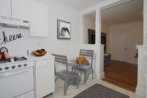 Cambridge apartment for rent - a kitchen and dining room with white appliances and a table and chairs