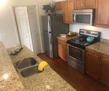 Beavercreek apartment for rent - a kitchen with stainless steel appliances and granite counter tops