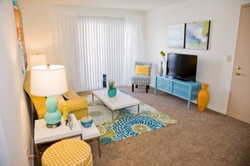 Batavia apartment for rent - a living room with yellow furniture and a television