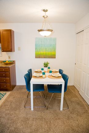 Batavia apartment for rent - a dining room with a table and chairs and a painting on the wall