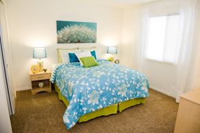 Batavia apartment for rent - a bedroom with a bed and two lamps and a window