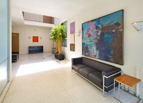 Los Angeles apartment for rent - a living room with a painting on the wall and a couch