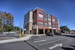 State College apartment for rent - a new apartment building on the corner of a parking lot
