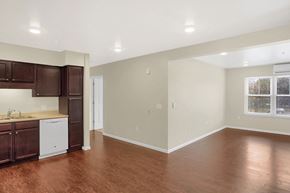 State College apartment for rent - an empty kitchen and living room with wood flooring and a window