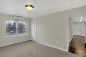 State College apartment for rent - an empty living room with a large window and a door
