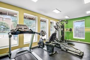 Silver Spring apartment for rent - A treadmill, a stationary bike, and a weight machine in a gym.