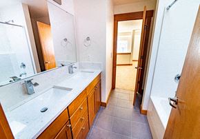 Seattle apartment for rent - a bathroom with a sink and a tub and a mirror